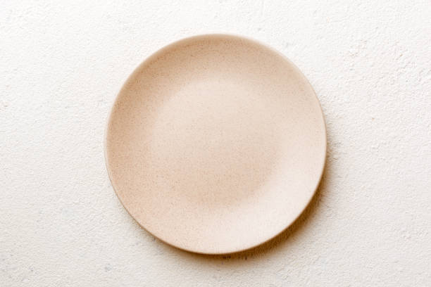 istock Top view of empty light plate on cement background. Empty space for your design 1463587156