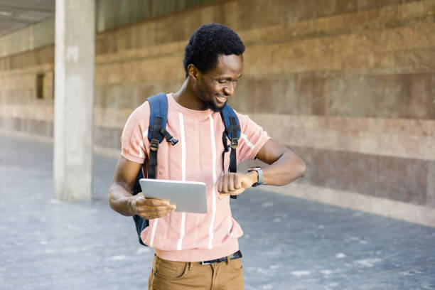 istock Portrait of a young African American using tablet and checking the time 1463588015