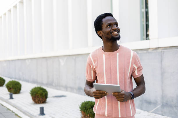 istock Happy young African American walking and making a video call 1463588017