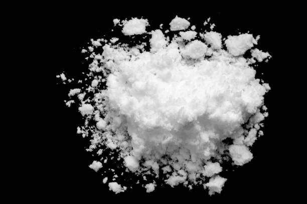 istock White snow isolated on black background close up 1463588413