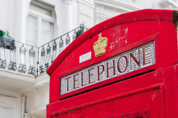istock Red phone box with white terraced house in the back 1463592252