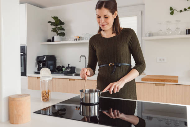 istock Pregnant woman in an apartment doing everyday stuff 1463592421