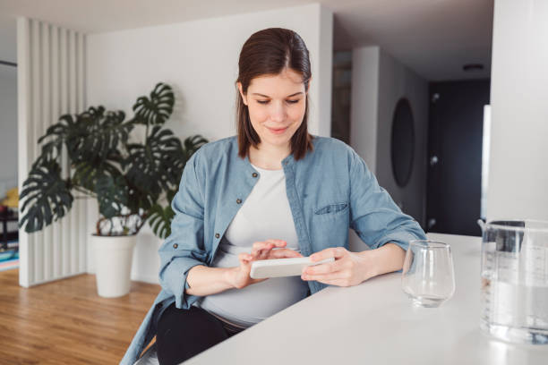 istock Pregnant woman in an apartment doing everyday stuff 1463592428