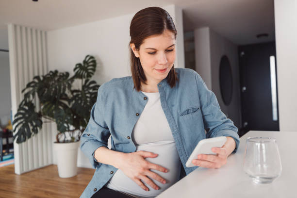 istock Pregnant woman in an apartment doing everyday stuff 1463592439