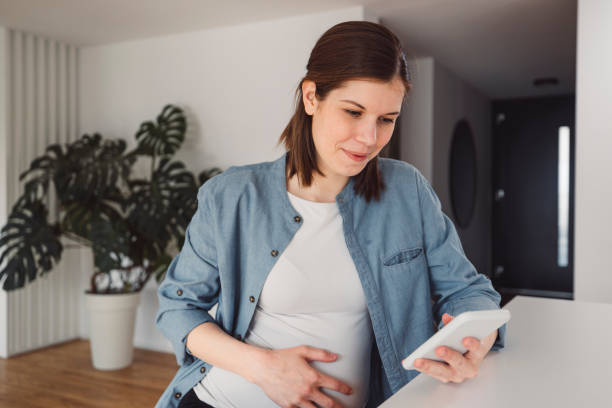 istock Pregnant woman in an apartment doing everyday stuff 1463592444