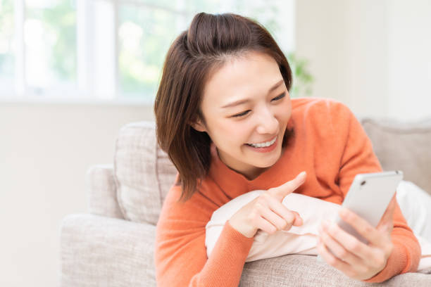 istock attractive Asian woman using a smart phone 1463593439