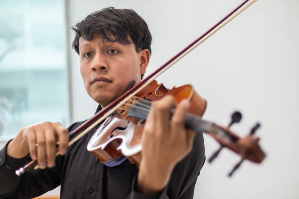 istock viola player, hispanic violinist or violist close up, young man playing viola 1463607366
