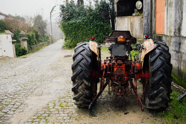 istock Old classic farm tractor parked in cobblestone street 1463609482