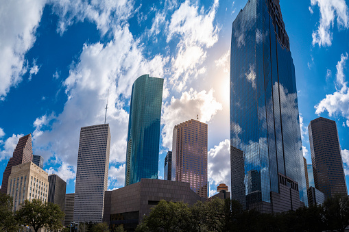 Houston Texas downtown buildings and city skyline metropolis landscape with dramatic clouds with glowing sun rays