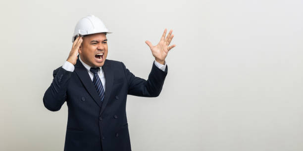 istock Depressed stressed Engineer. Young asian businessman on isolated white background. Angry middle aged Indian businessman in office uniform. 1463615774