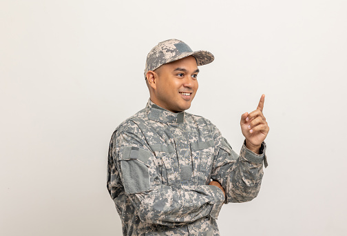 Pointing blank space. Asian man special forces soldier standing in studio. Commander Army soldier military defender of the nation in uniform standing on white background.
