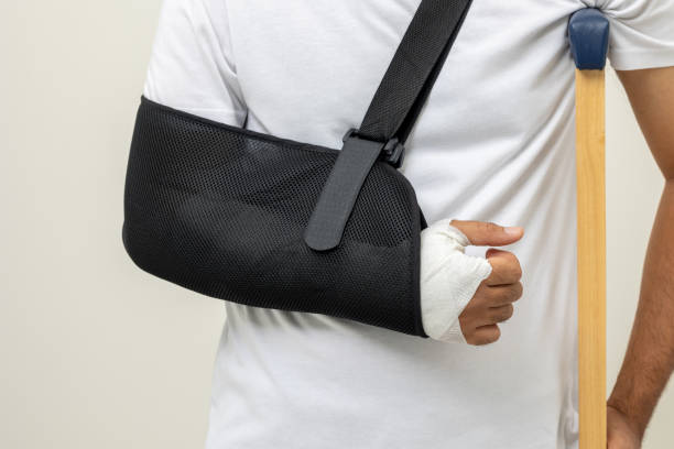 istock Young man broken arm and leg on isolated. Man put on plaster cast splint with walking sticks crutches. Patient wearing sling support arm with neck collar. life insurance and accident 1463615941
