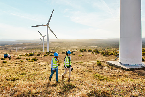 Wind turbine, engineering people and renewable energy for sustainability, farming field and inspection on sky mockup. Clean energy, sustainable and electricity windmill with worker or farmer teamwork