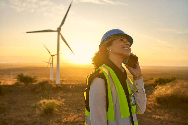 Phone call, wind turbine and engineer on sustainable farm for maintenance, repair or building. Agriculture, cellphone and woman industry worker on mobile conversation by natural field in countryside. Phone call, wind turbine and engineer on sustainable farm for maintenance, repair or building. Agriculture, cellphone and woman industry worker on mobile conversation by natural field in countryside. electrician smiling stock pictures, royalty-free photos & images