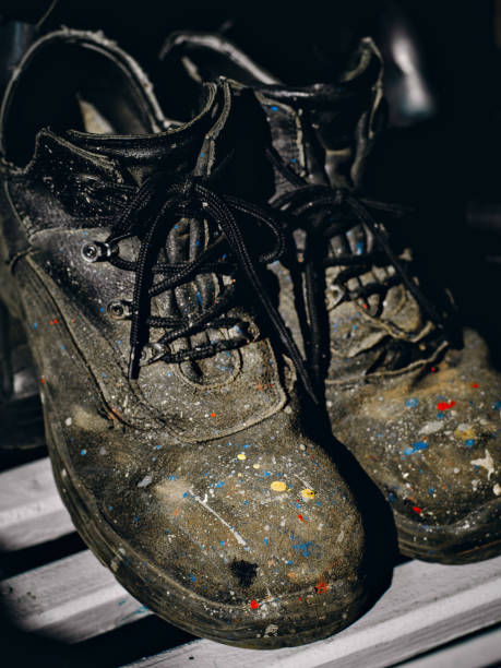 istock Working shoes. Old paint-stained boots and worn-out industrial painter boots. Background. 1463622151