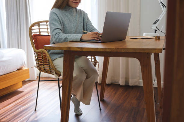 istock Closeup image of a young woman working on laptop computer at home 1463622252