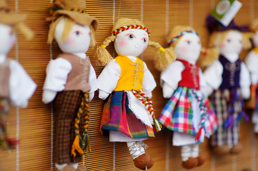 Cute handmade ragdoll dolls in Lithuanian national costumes sold on Easter market in Vilnius. Lithuanian capital's annual traditional crafts fair is held every March on Old Town streets.