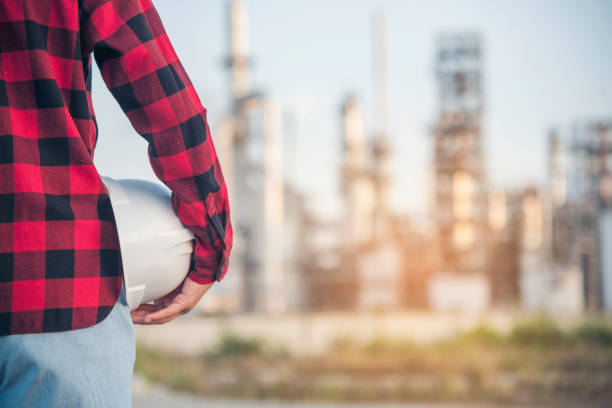istock Engineer woman hands holding hardhat white work helmet hard hat for Construction Engineering. Refinery woman engineer oil industry hands hold worker helmet hard hat. Refinery industry engineering 1463629696