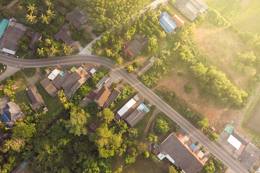 road and small town at sunrise aerial view