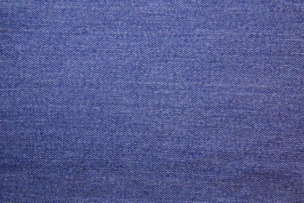 Blue jeans fabric background texture. Blue fabric cloth textile material.