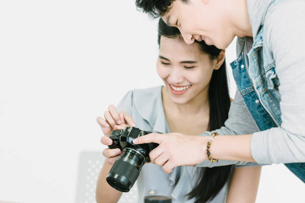 istock Asian Photographer and model looking pictures from camera 1463641331