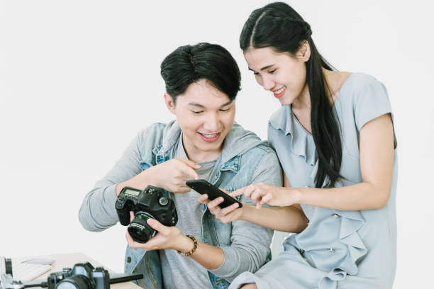 istock Asian Photographer and model looking pictures from camera 1463641470