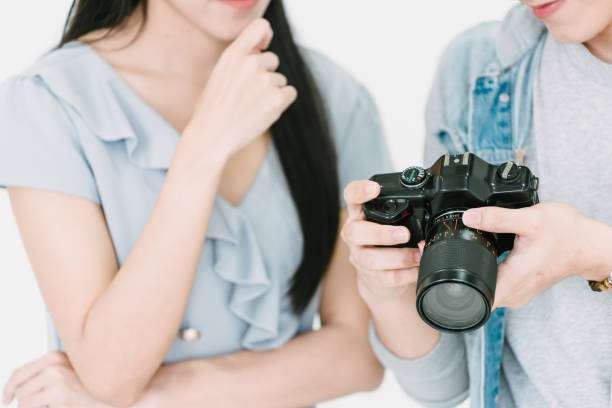 istock Asian Photographer and model looking pictures from camera 1463641750