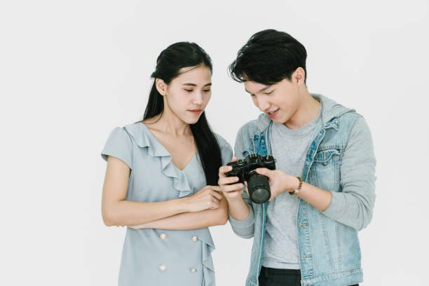 istock Asian Photographer and model looking pictures from camera 1463641841