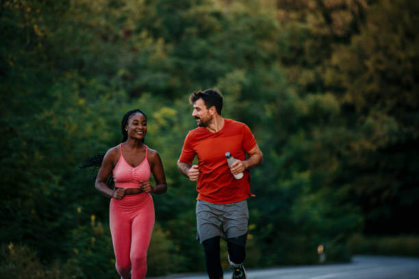 istock Fit young couple running along a trial 1463644767