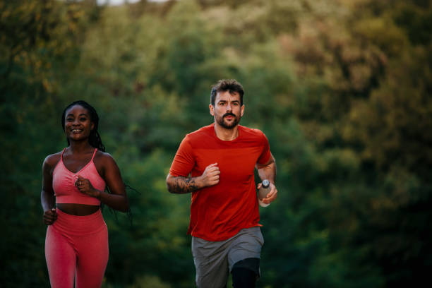 istock Fit young couple running along a trial 1463644779