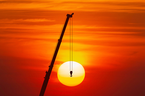 contruction site and crane and sunset