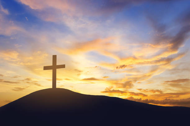 istock sunrise and cross on mountain 1463648612