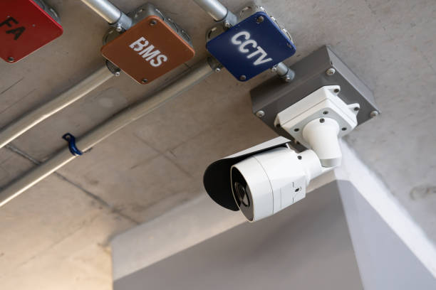 istock Security white CCTV (Closed-circuit television) camera in the office building. CCTV camera white on a white body. 1463651011