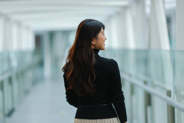 istock Beautiful young woman relaxing at modern corridor 1463651295