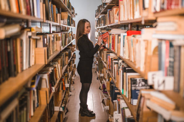 istock The librarian chooses which book to read 1463653300