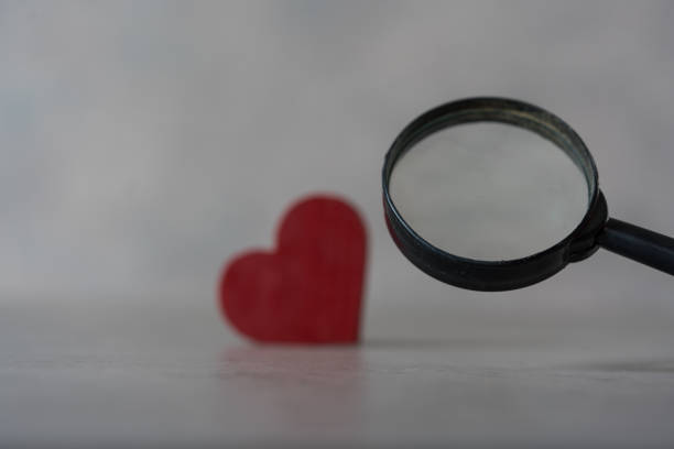 istock Love concept with red heart object with magnifying glass 1463657392