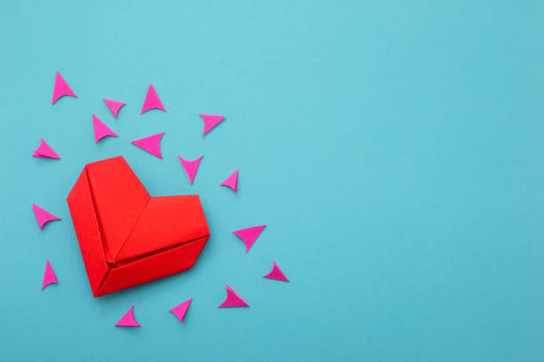 istock Red heart paper folded on blue background. 1463657975