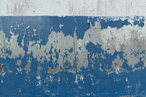 peeling blue paint on old wall background