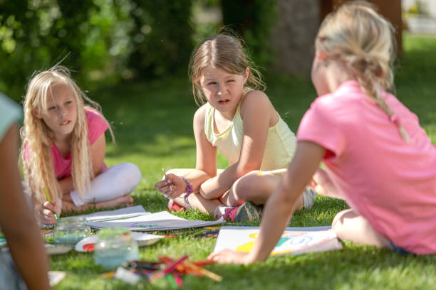 istock Girls drawing in garden 1463662041