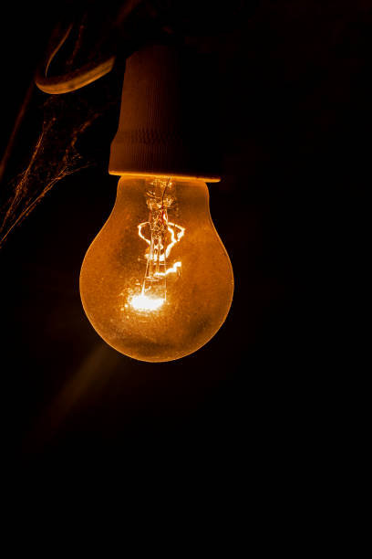 istock weakly burning electric light bulb in the dark with cobwebs. blackout, saving electricity 1463665008