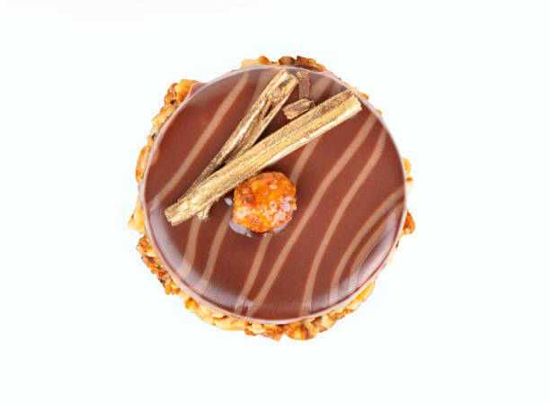 istock Chocolate brownie with mascarpone syrup and salted caramel inside, decorated with nuts isolated on white background 1463670362
