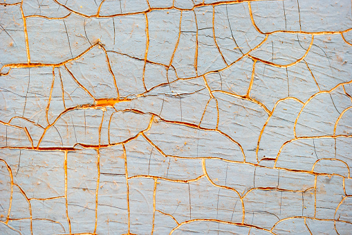 Background of old cracked blue sun-bleached paint on wood.
