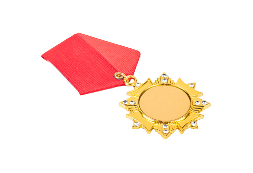Gold medal in the shape of a star with a red ribbon on the chest isolated on a white background.