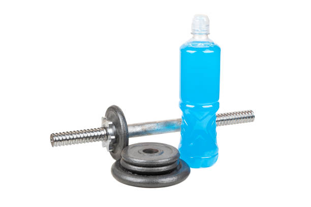 Blue isotonic drinks with dumbbell and pancakes isolated on white background.