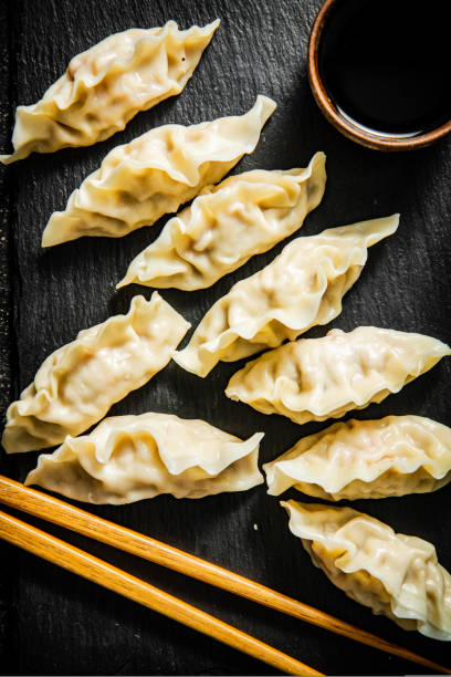 istock Dumplings gyoza on a stone board with soy sauce. 1463675766