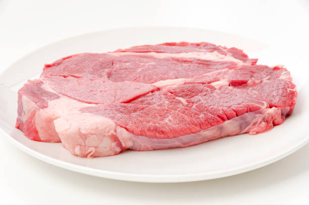 istock Fresh raw beef steak on white plate on white background 1463677975