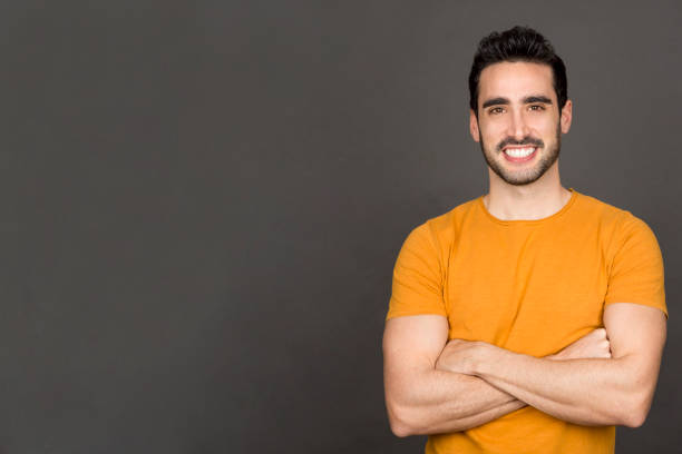istock Happy man smiling at the camera while crossing the arms 1463679335