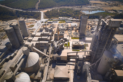 Structures of cement producing plant. Aerial view of huge industrial factory.