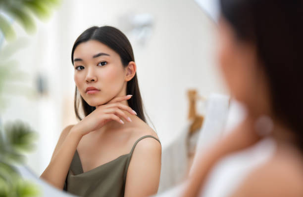 istock woman looking at mirror 1463681656