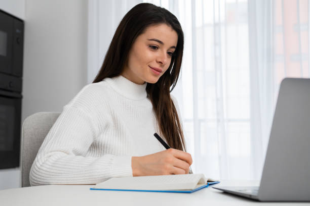 istock Focused young female college student preparing for exams and watching webinars 1463686814